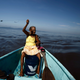Cecilia Villegas, 77, throws a fishing line along the sea of the Pacific coast of Cano Ciego Island